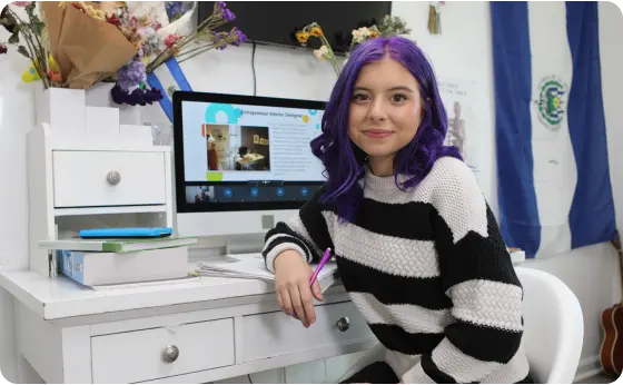 Student attending to an online class wearing a stripped sweater