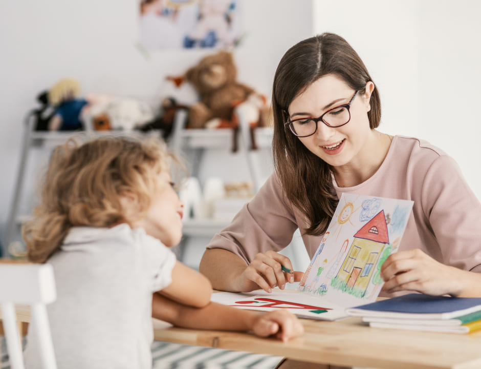 Education student drawing with a little girl