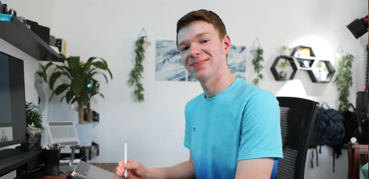 High school student taking notes at home wearing a light blue tshirt